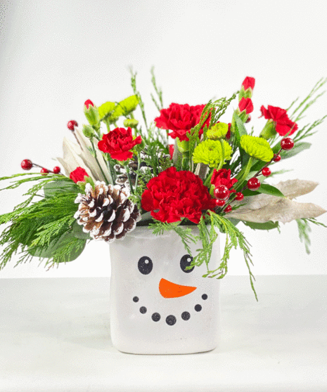 red and green flowers in snowman vase